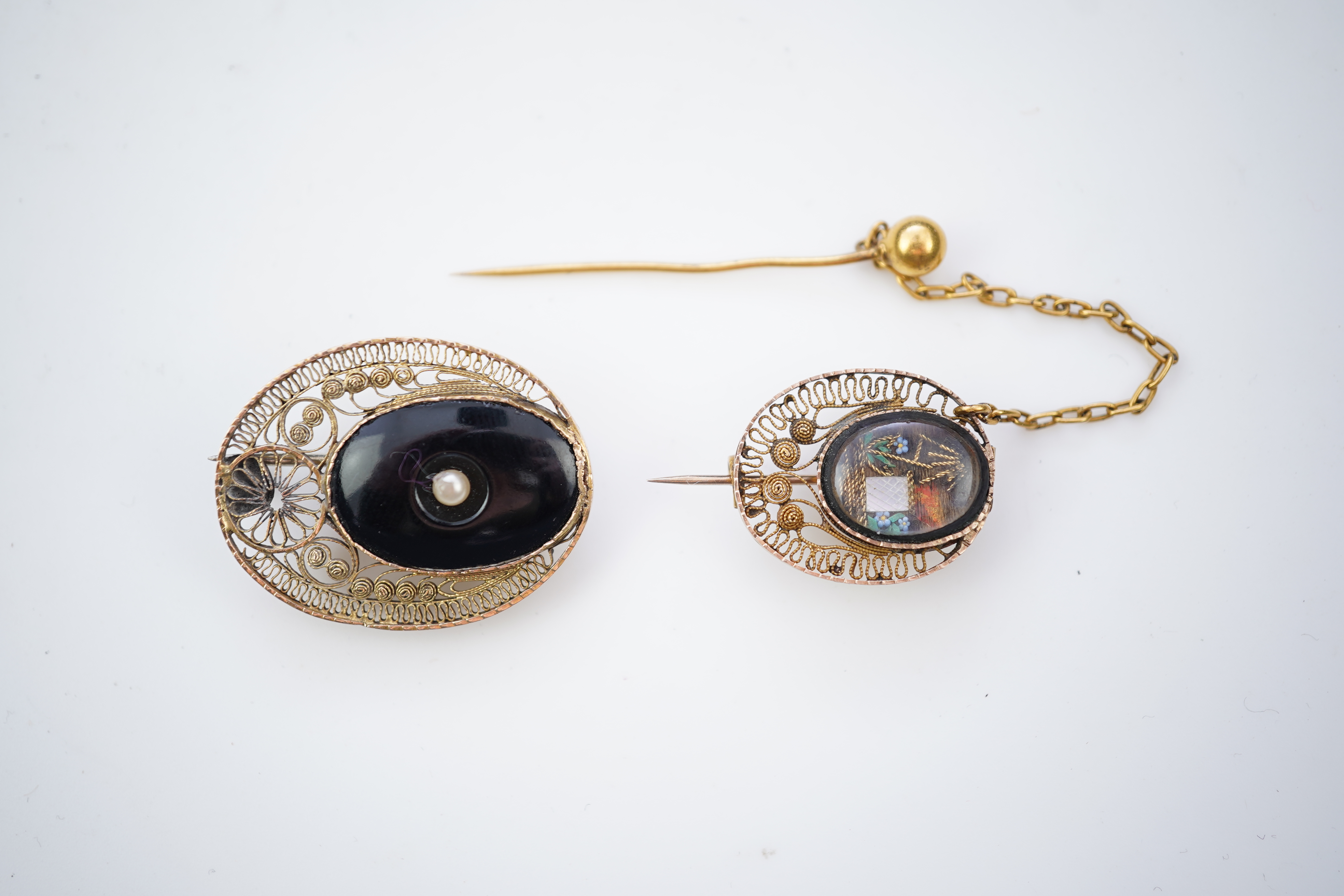 A collection of shell cameo brooches, comprising: a cameo depicting Bacchus, in a gold mount in the Archaeological Revival style, decorated with rope twist and a twisted knife wire border, length 4.4cm; together with sev